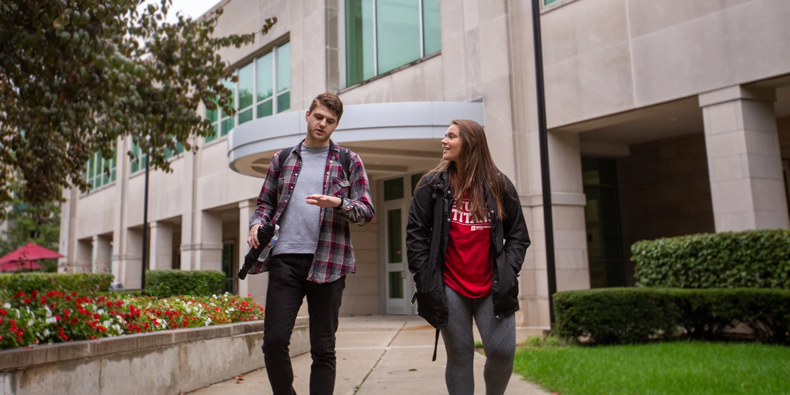 Two students walking on campus.