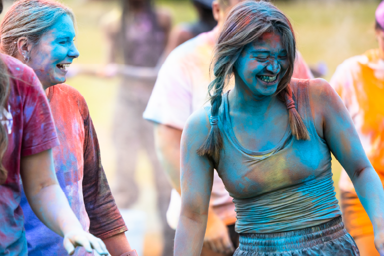 Students splattered with colored powder during a color run